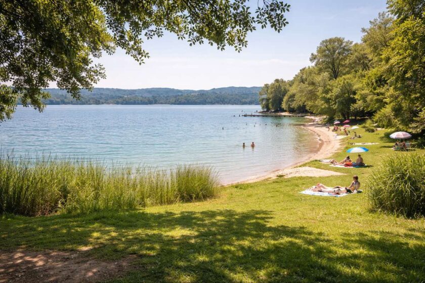 Panorama delle spiagge lago di Monate con acqua limpida e riva verde in Lombardia